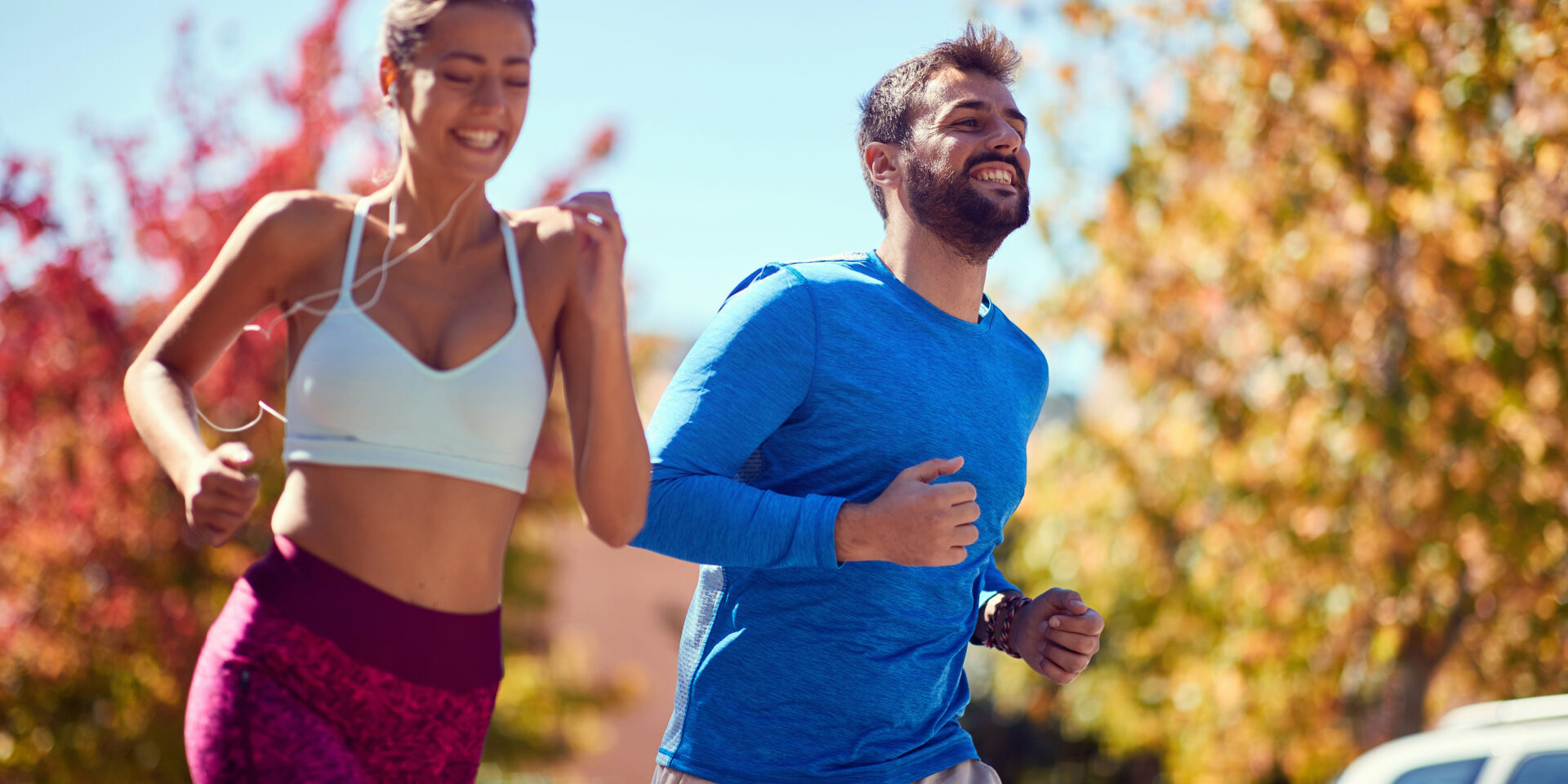 Young happy man and woman jogging at the park. healthy lifestyle.